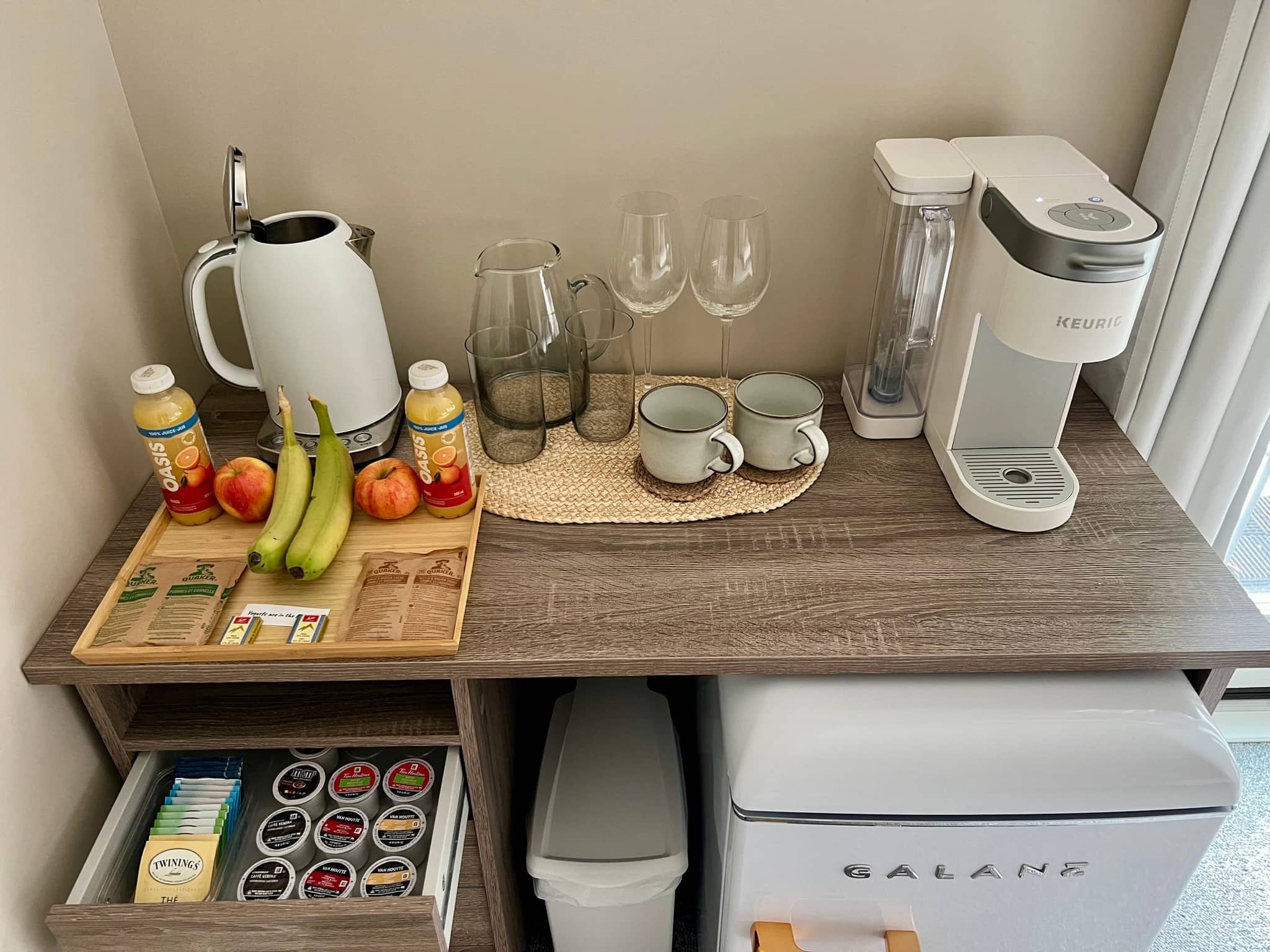 In-suite coffee station with Keurig machine, pods and tea selection