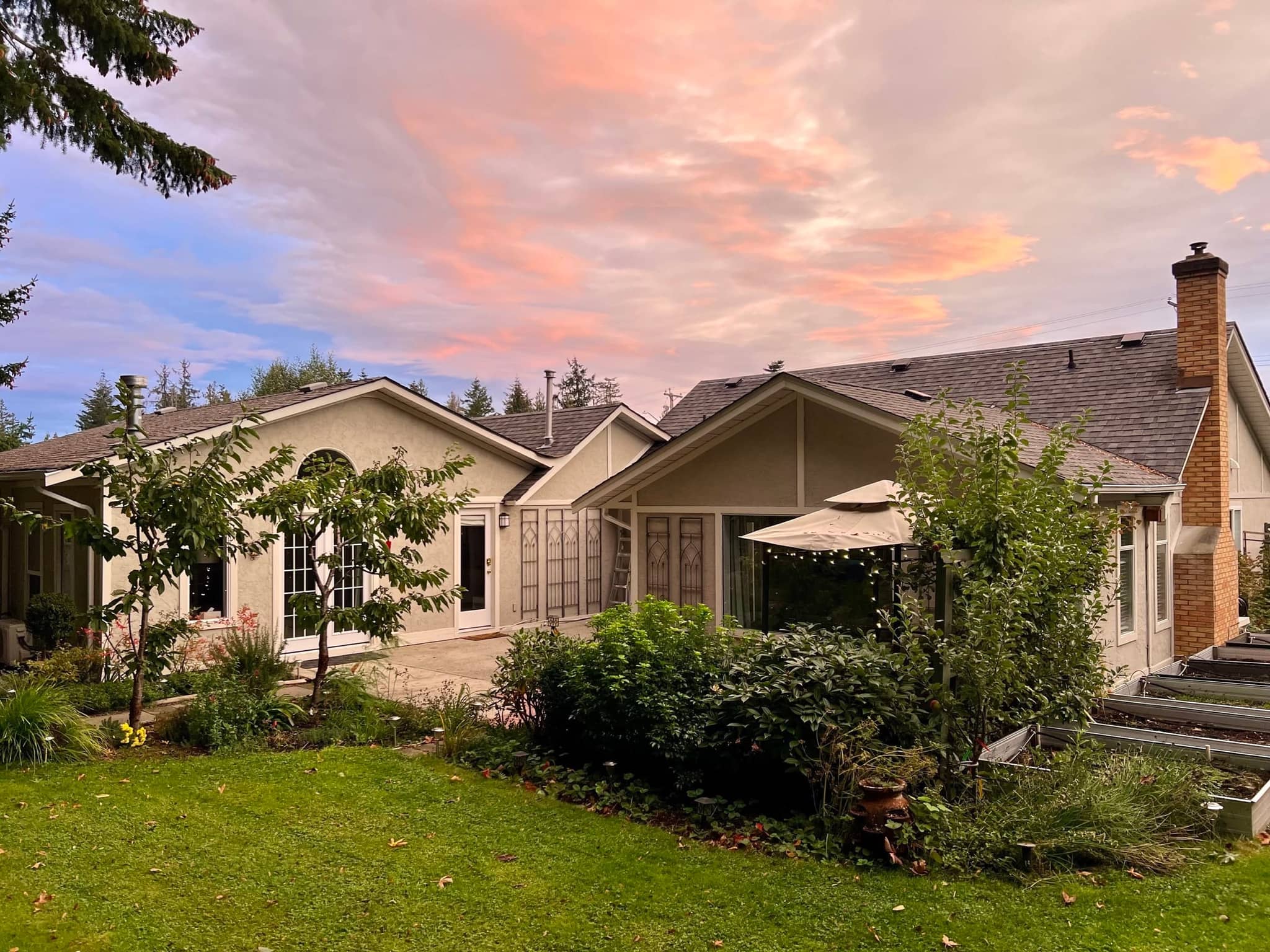 Five Gables suite and garden under a pink sunset sky in Qualicum Beach