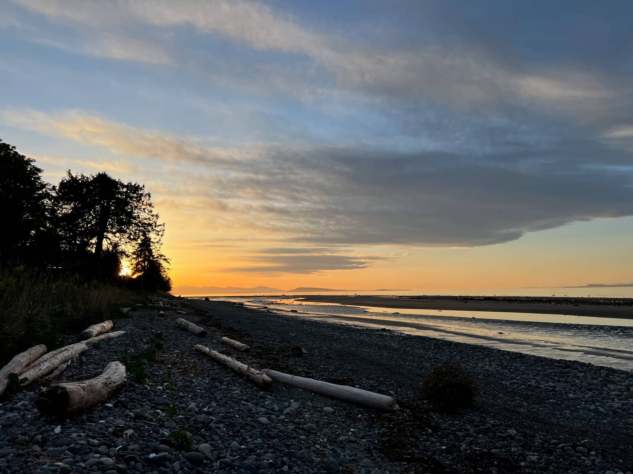 Sunset glow over the water from the pebble beach in Eaglecrest, Qualicum Beach, a short walk from Five Gables
