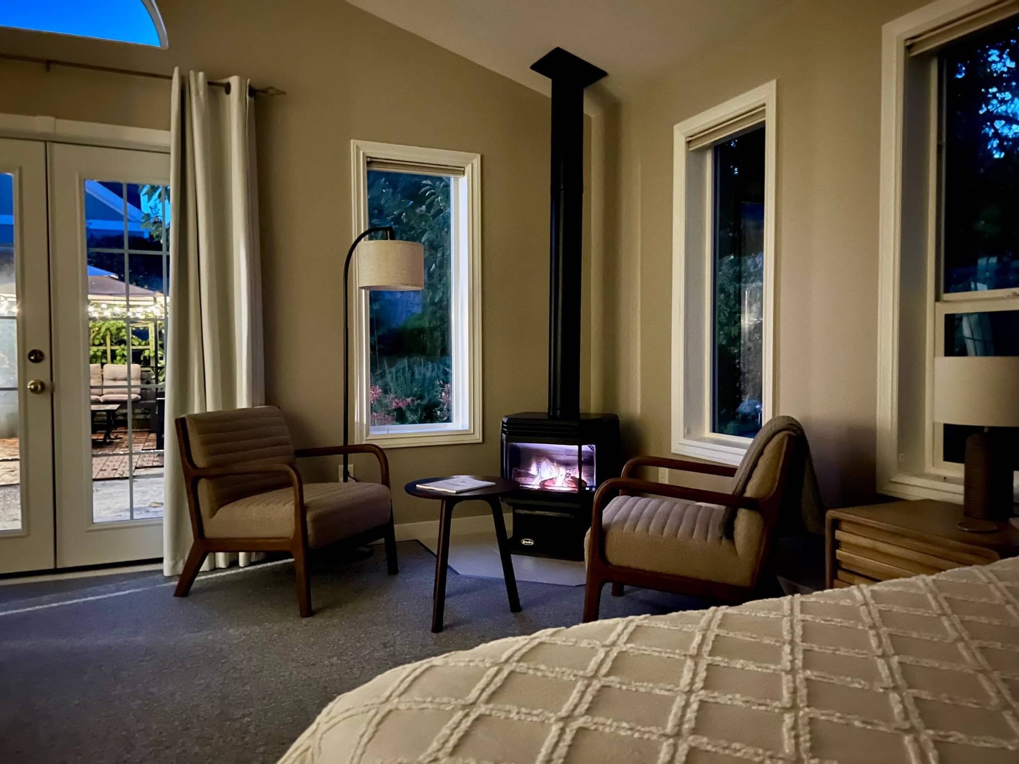 Sitting area with two armchairs and a small table beside the gas fireplace